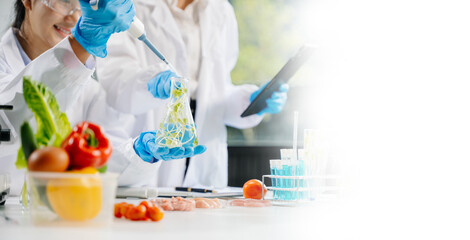 Food scientists in lab coats, testing samples, and analyzing food safety and quality in a laboratory