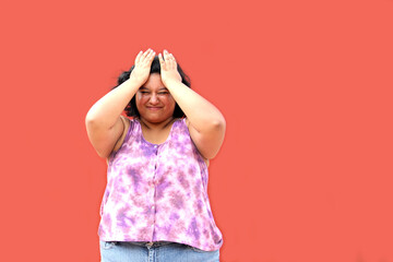 Young 20 year old Latin brunette woman suffers from headache due to stress and migraine