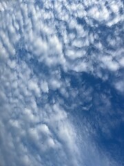 Natural sky background, fantastic cloudscape, blue sky and many small white clouds, heavens