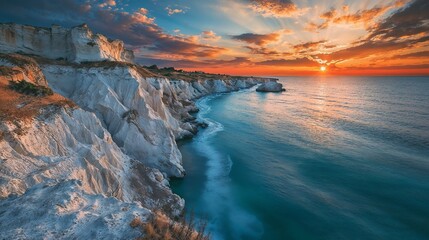 A breathtaking view of a stunning cliff overlooking the ocean during sunset
