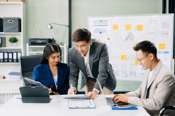 Office colleagues have a casual discussion. During a meeting in a conference room, a group of business teem