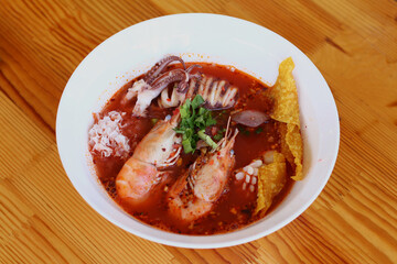 Traditional Thai Soup on Wood or Thai Shrimp Soup on Wooden Surface