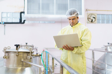 Quality control supervisor checking and collecting food and beverage producing data.