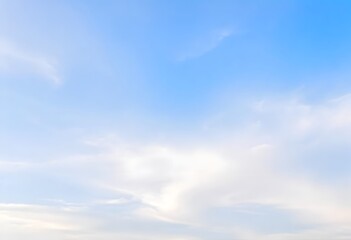 Obraz premium Clear blue sky with a single, fluffy white cloud drifting across it