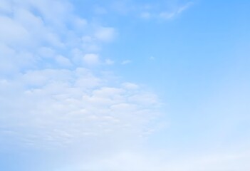 Fototapeta premium Clear blue sky with a single, fluffy white cloud drifting across it