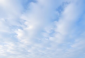 Fototapeta premium Clear blue sky with a single, fluffy white cloud drifting across it