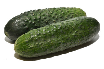 Two green cucumbers on a white background, close-up.
