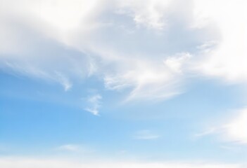 Fototapeta premium Clear blue sky with fluffy white clouds drifting slowly