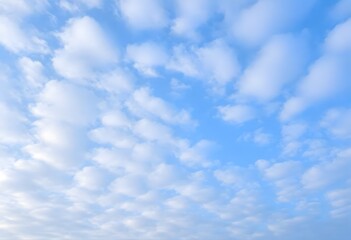Fototapeta premium Clear blue sky with fluffy white clouds drifting slowly