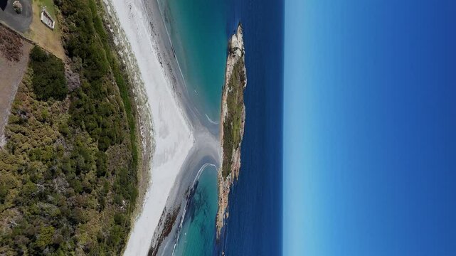 Aerial of Diamond Island Bicheno and the azure waters in Tasmania, Australia. Vertical shot.