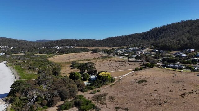 Panoramic view of the white sandy beach and the town of Bicheno in Tasmania, Australia.