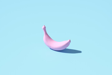 Pink banana casting shadow on pastel blue background
