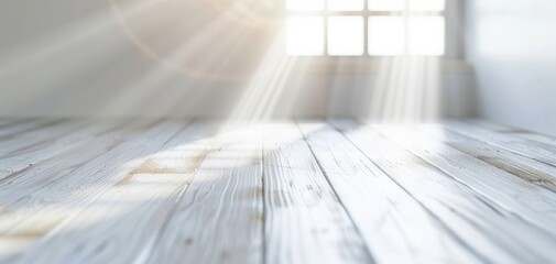 Bright sun rays streaming through a window, illuminating a wooden floor in an airy, peaceful indoor space.