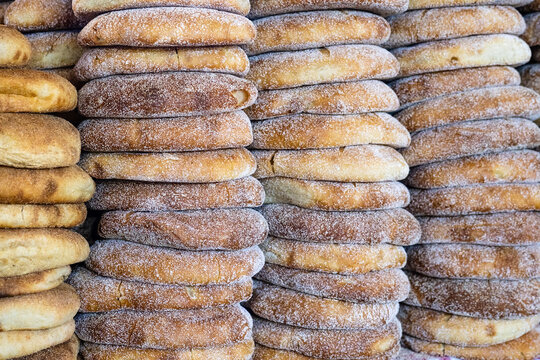 Stack of fresh Moroccan bread at street market stall. Traditional freshly baked bread called khubz, batbout, Mkhamer or harcha in Morocco
