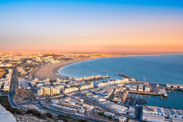 Agadir, Morocco at sunset. Panoramic view of Agadir city and bay in southern Morocco with Marina, beach and ocean from Oufla or Casbah fortress. Moroccan seaside resort on Atlantic coast in Africa