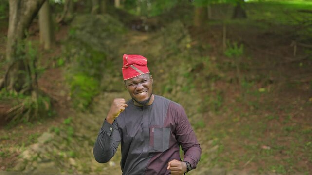 Excited African-American man screams and gives two thumbs up.
