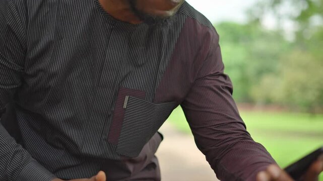 Panning shot away as Yoruba African man dances and gives thumb up.