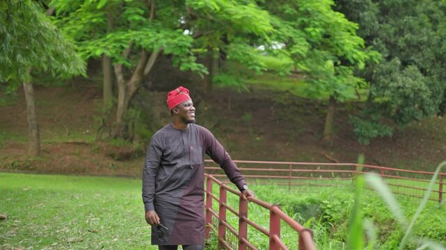 Dark skin Yoruba man removes sunshades and smiles into the future.
 