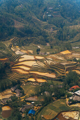Behold the Stunning Aerial View of Terraced Rice Fields Set Against a Lush, Vibrant Landscape