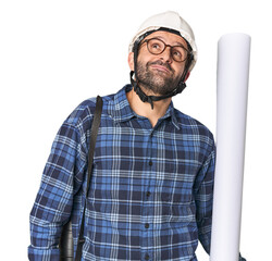 Hispanic male architect with plans dreaming of achieving goals and purposes