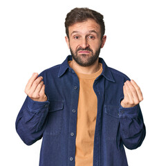 Studio portrait of young Hispanic male showing that she has no money.