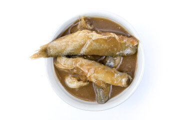 A cup of pickled fish isolated on white background top view flat lay stack. Preserves fish by keeping it in brine and roasted rice over a period without refrigeration, ingredient for cooking Thai dish