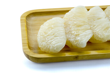 Group of fresh pomelo citrus fruit or grape fruit ,ready to eat,  in wooden tray isolated on white background, stack closed up, clipping path, copy space.