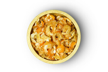 A wooden cup of dried shrimp isolated on white background with clipping path top view flat lay. Sun dried seafood imparting a umami taste.