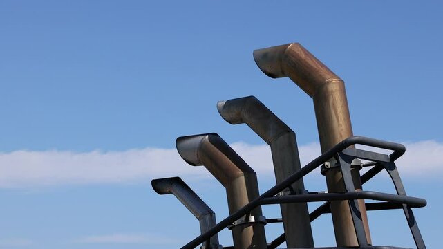 Industrial Chimneys Against Blue Sky