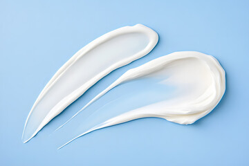 White cream smear top view isolated on a blue background