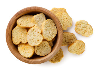 Croutons baguettes in a wooden plate close-up on a white background. Isolated
