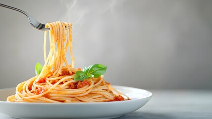 Elegant Fork Twirling Spaghetti with Tomato Sauce and Fresh Basil - Delicious Pasta Dish Captured with Rich Colors and Strands of Flavor Against Simple Background