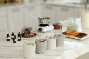 Forms standing on table preparing for handmade candles