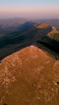 Aerial view of Pyramid shape shade of Rtanj mountain peak Siljak at morning sunrise.