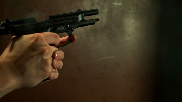 Super Slow Motion of Shooting Pistol in Man's Hands. Filmed on High Speed Cinema Camera, 1000fps.