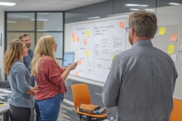 Obraz premium Corporate meeting in a conference room, with a team brainstorming ideas on a whiteboard.