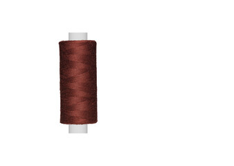 brown spool of sewing thread isolated on white background close up