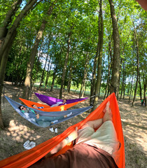 Relaxing in Colorful Hammocks in the Forest