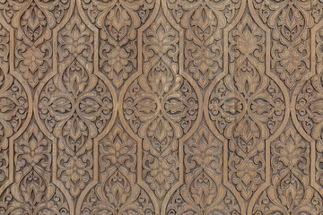 Islamic style geometric carving detail with intricate star shapes from a door of a mosque, traditional handcrafted oriental architectural fragment background