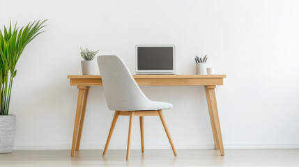 Natural wood desk with stylish chair in a minimalist home office setup featuring a potted plant next to a sleek laptop for a modern and productive workspace.