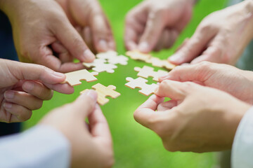 Coworker's hand holding jigsaw puzzle With the cooperation of business people team joins together to campaign Environment, Society and Corporate Governance. Sustainable corporate social, environmental