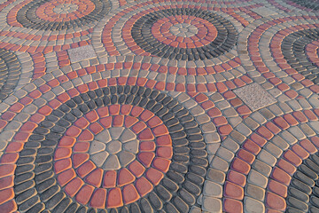 Round colorful pavement on sunny day in public park. Colorful paving stones in urban park landscaping design. Tile circles in garden