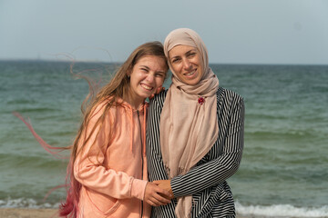 Muslims on the beach, mother with daughter, hijab, girls in hijab lesbians, rest of Muslims at sea, travel, Muslims, same-sex love, lesbians, Muslims and Christians, faith, confessions