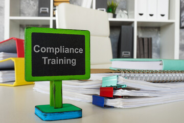 Compliance training sign on office desk. Corporate responsibility concept.