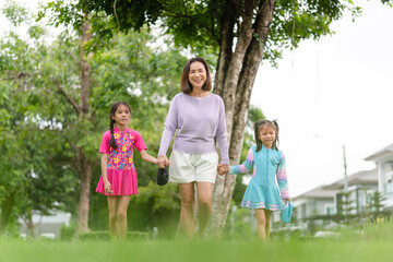 Fototapeta premium Asian mother and daughter walking outdoor go to swimming pool