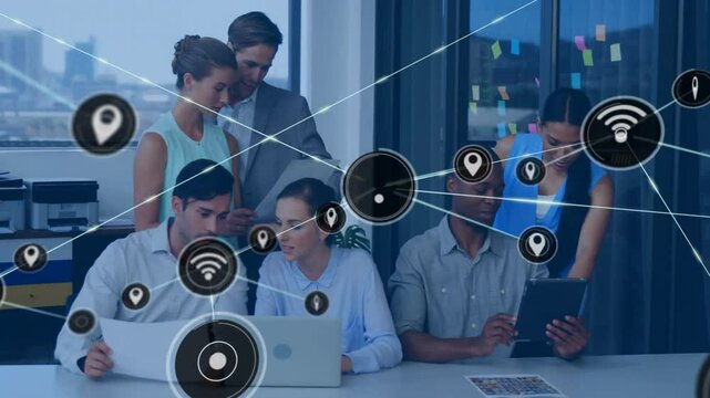 Animation of network of connections with icons over diverse colleagues discussing work in office