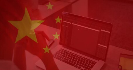 Animation of flag of china over caucasian businesswoman using laptop - Powered by Adobe
