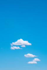 Blue sky vertical background with fluffy cloud floating on the bright summer sky in minimal style...