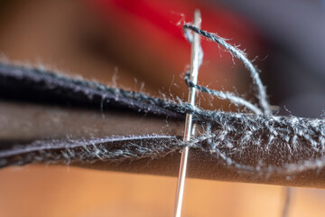 Close up of men works the leather in craftsman workshop. Handmade genuine leather production in the factory. leather craft 