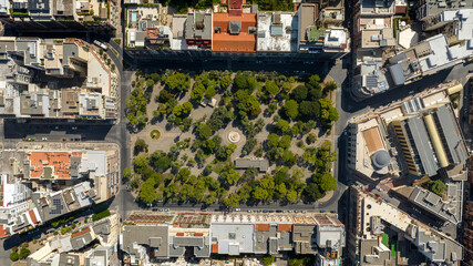 Fototapeta premium Zenithal aerial view of Garibaldi Gardens in Bari, Puglia, Italy. It is a large green area with a park and trees in the city.